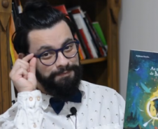 Homem segura capa de livro