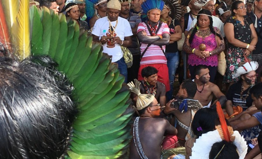 No primeiro plano a nuca de um índio que fala para uma audiência em Brasília ao fundo