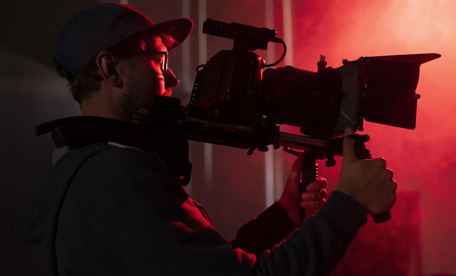 Foto ilustrativa de cinegrafista segurando uma filmadora